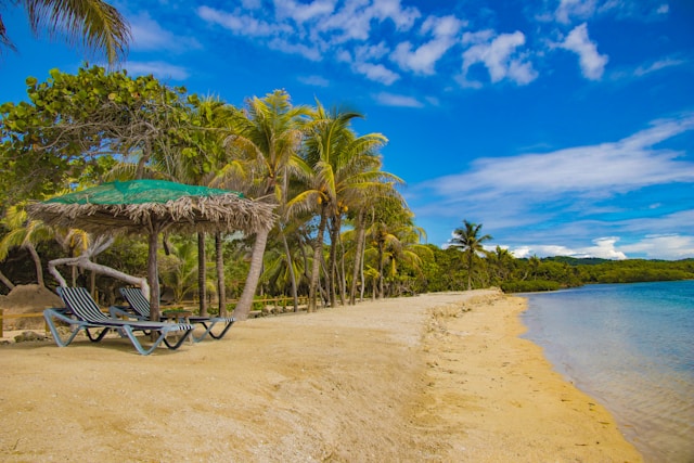 Serene beach scene featuring lounge chair and umbrella